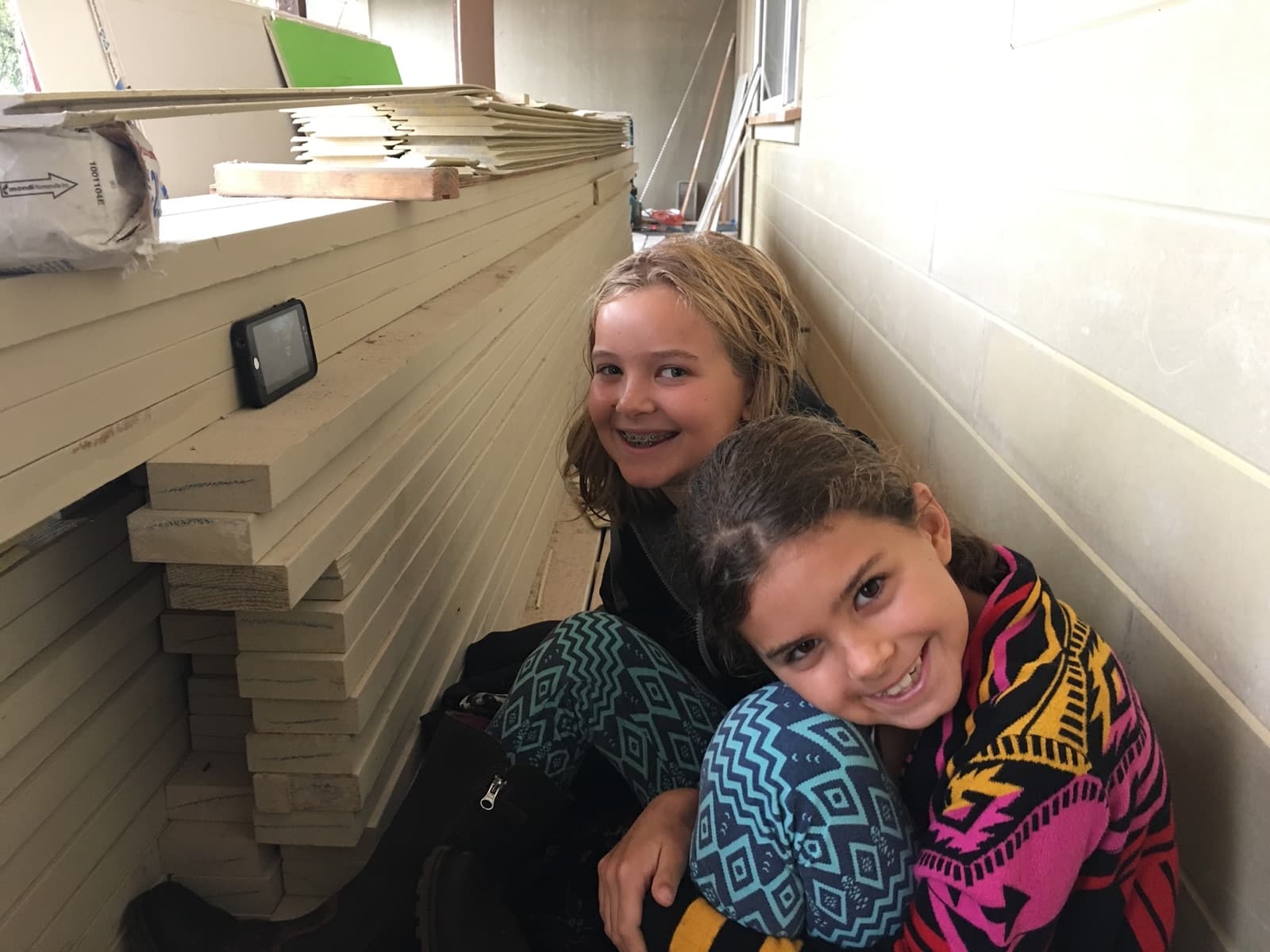 Our two daughters, smiling together on one of our job sites.